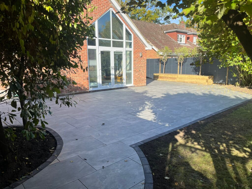 Raised Sleeper Planter, Grey Double-Slatted Venetian Fence, and Porcelain Patio Installation