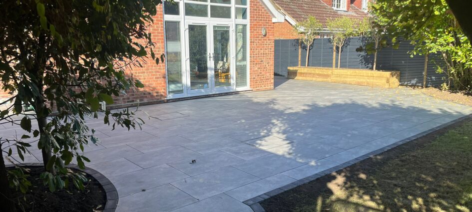 Raised Sleeper Planter, Grey Double-Slatted Venetian Fence, and Porcelain Patio Installation